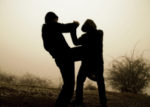 Photo of two men fighting in a field.