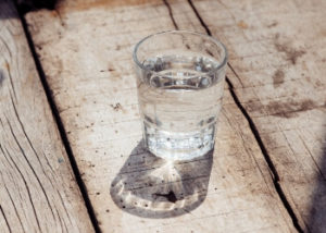 Image of a glass of water sitting in the sunlight.