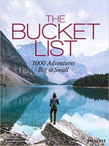 cover of the book THE BUCKET LIST, showing a person standing in front of a mountain lake