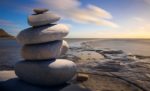 a stack of stones on the beach.. #How I Got Over Imposter Syndrome #what is imposter syndrome #definition of imposter syndrome #how to use positive affirmations #how do you write positive affirmations