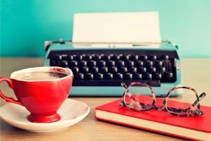 coffee cup, book, glasses, typewriter. HOW TO FIND A LITERARY AGENT #book agents #book publishing agent #do I need a literary agent to get published #finding a literary agent for fiction #getting a literary agent #how to get a literary agent to represent you