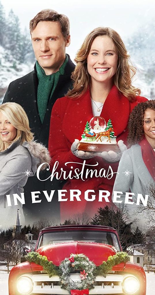 movie poster of the Hallmark movie CHRISTMAS IN EVERGREEN: smiling heroine in a red coat holding a snow globe, handsome leading man, supporting characters
