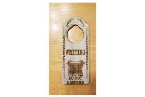 wooden door hanger with a typewriter design and the words WRITING - DO NOT DISTURB