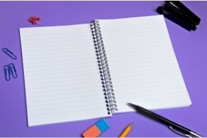 50 Essay Topics for Kids | image: Open blank notebook and pen