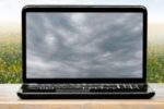 laptop with storm clouds on screen