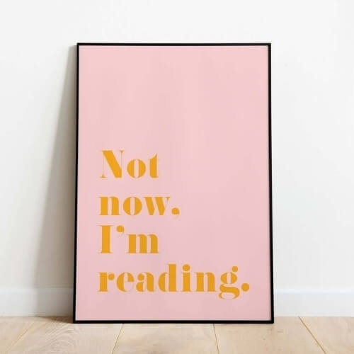 framed print that reads "Not now, I'm reading."