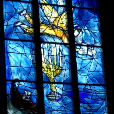 closeup of one of the America windows by Chagall; candleabra, winged figure holding dove