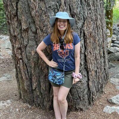 Bryn dressed for hiking near a big tree in Yosemite