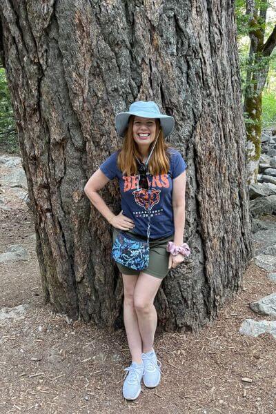 Bryn dressed for hiking near a big tree in Yosemite