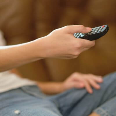 woman's hand with remote