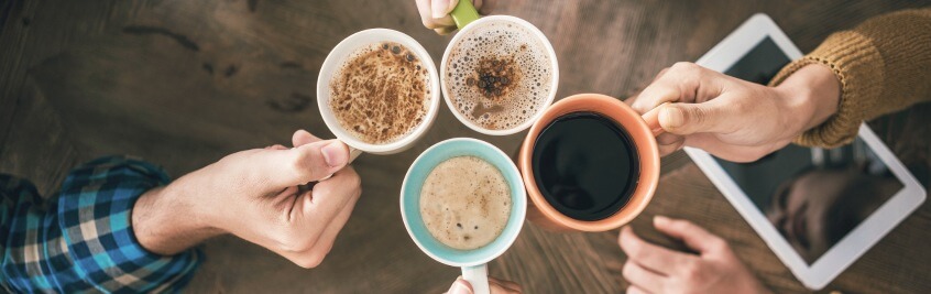 mugs of friends meeting at coffee shop