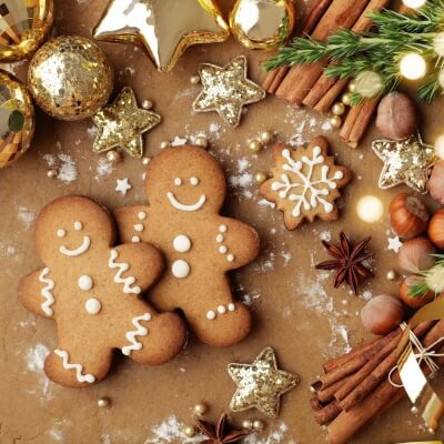 smiling gingerbread people, cinnamon sticks, and Christmas ornaments - Christmas Scents