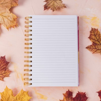 autumn leaves and notebook, ready for fall writing prompts 